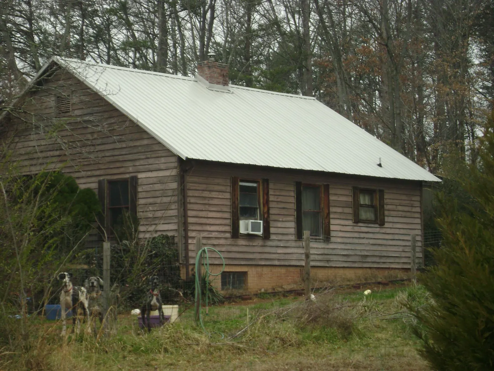 White metal roof on an old wood sided farmhouse, from a Metal Roof Installation job in Westphalia